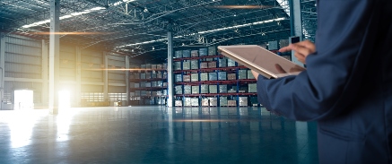 Business man with ipad in stock room_for WordPress