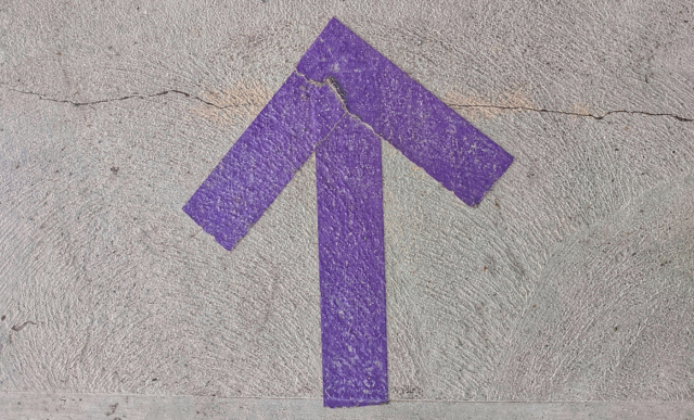 An arrow pointing up, painted on tarmac | Mindset Consulting
