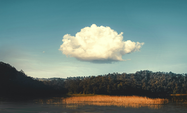 A single cloud appears in the sky above a lake | Informatica
