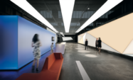 Individuals walking through a corridor in the Zumtobel Group building | Xiting
