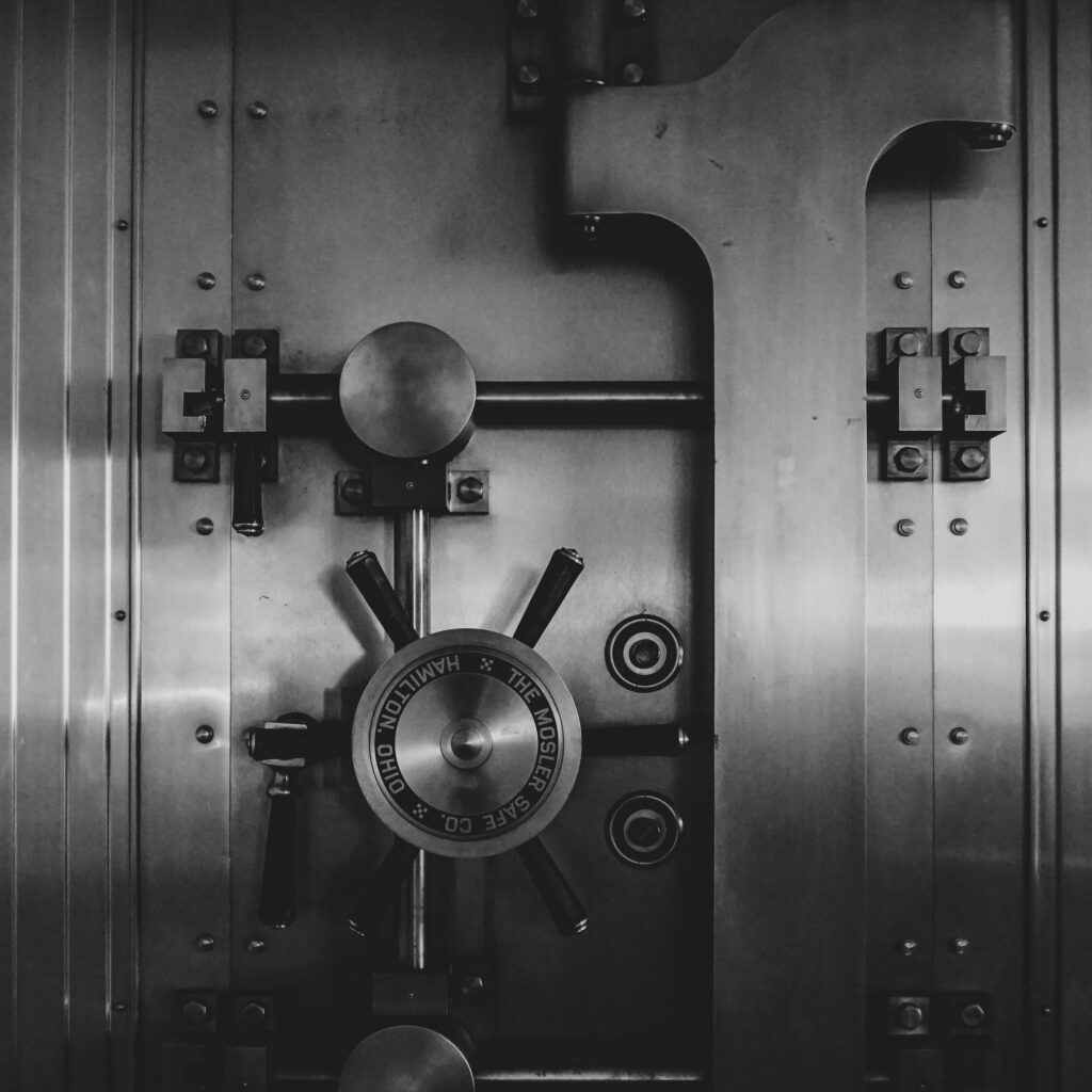 A black and white photograph of a large safe vault.