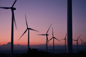 a photograph of wind turbines in the sunset; AI and automation solutions concept
