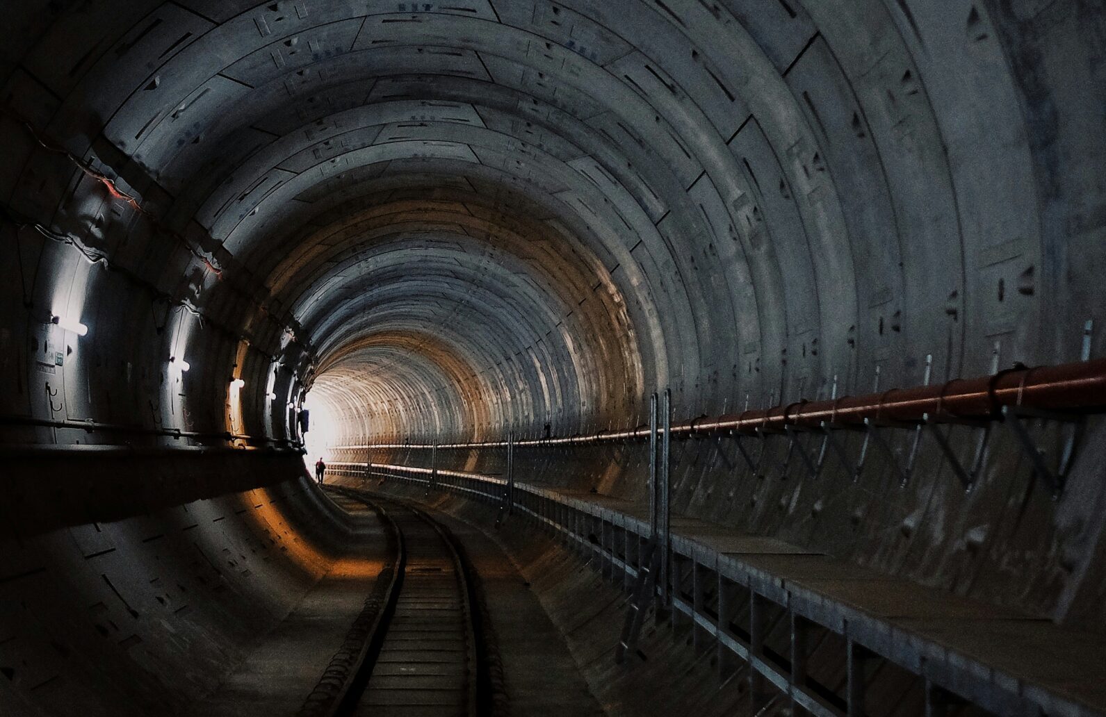 photo of light at the end of a tunnel and a person walking toward it | REALTECH SmartChange solution for SAP Transport Management and in-process quality checks