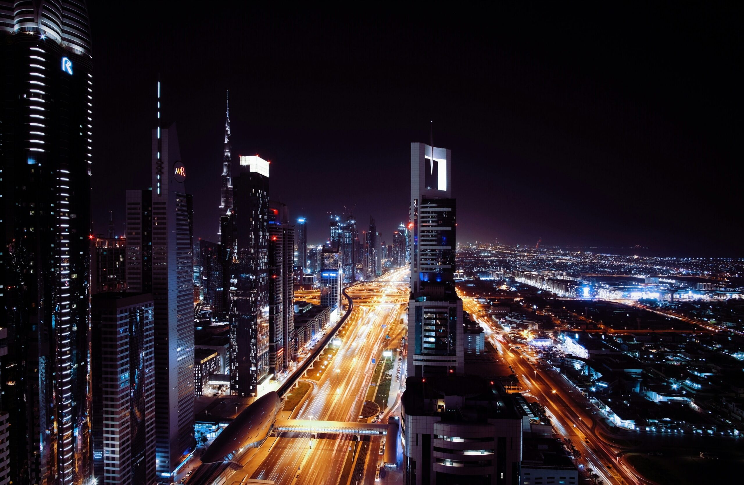 Image of a smart city at night, lights of traffic everywhere | CNT Management Consulting brownfield