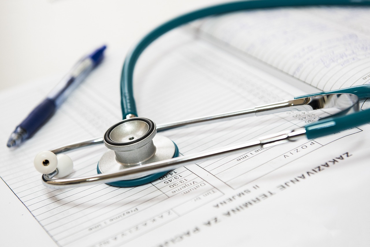 stethoscope placed on a book of medical logs