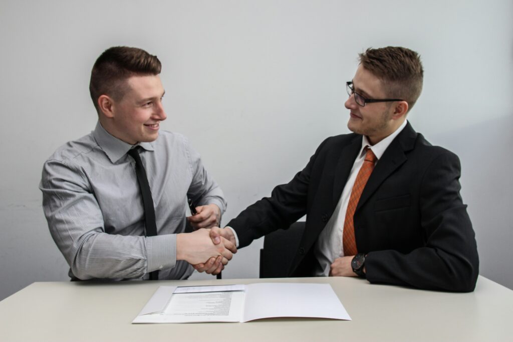 two businessmen shaking hands | Qubittron services for SAP BTP implementation