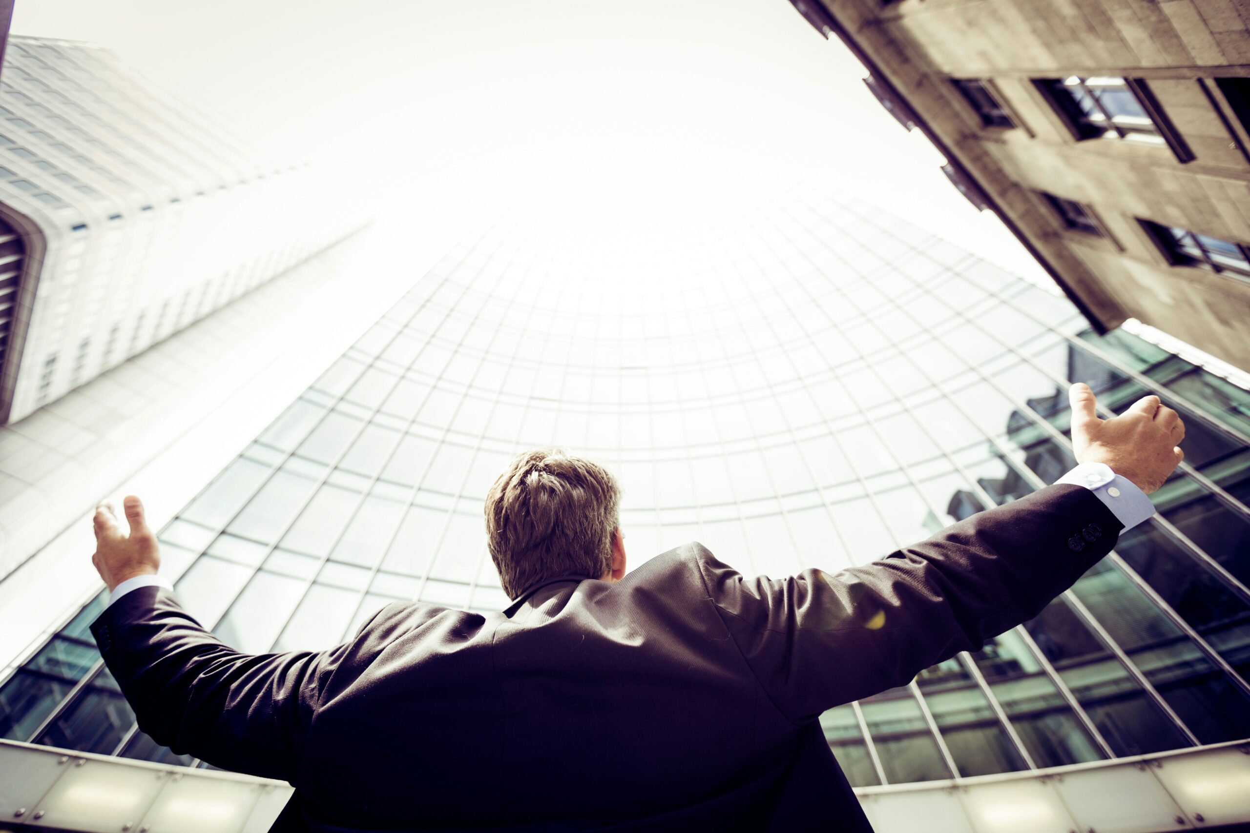 a person looking up to the sky with open hands