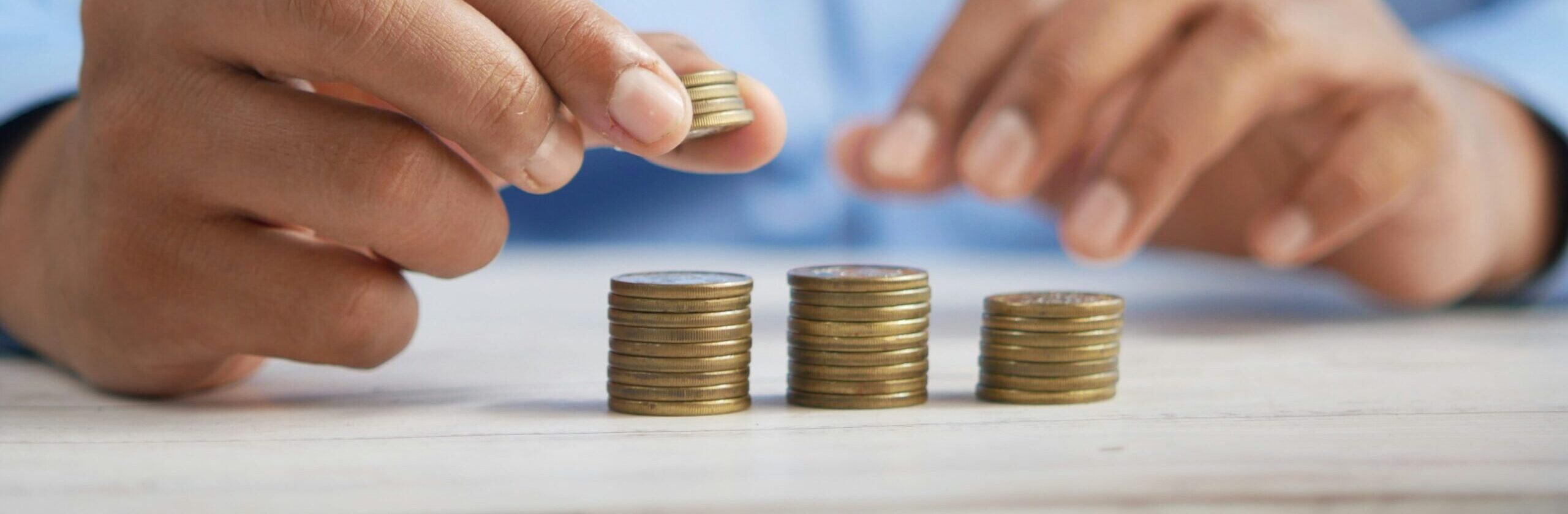 man stacking coins