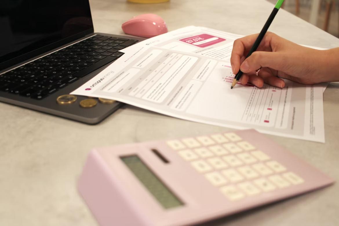 Business professional calculating invoices with calculator, representing SAP finance workflows and intelligent document processing in accounts payable.