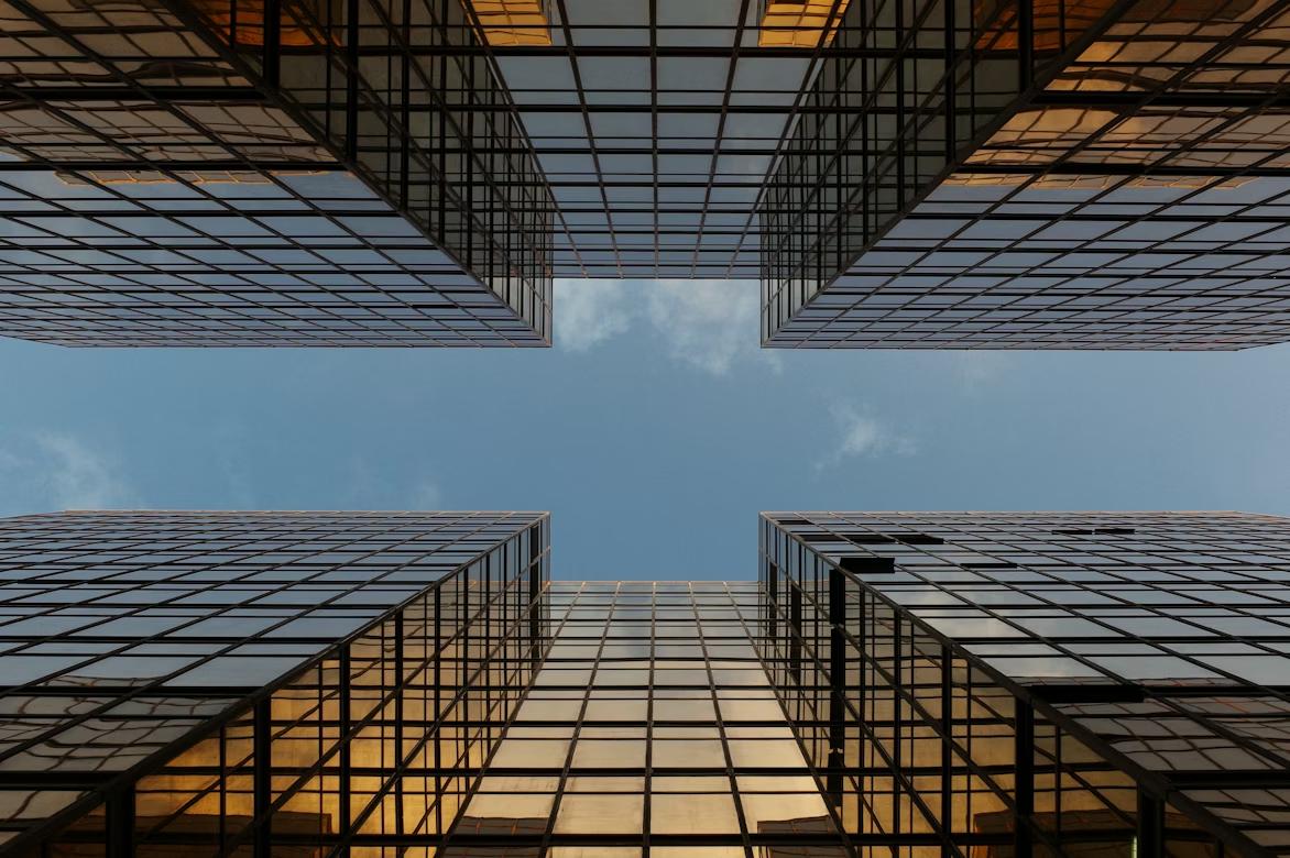 Office buildings from below, representing the financial close and consolidation processes visualized through data alignment and workflow automation across enterprise systems.