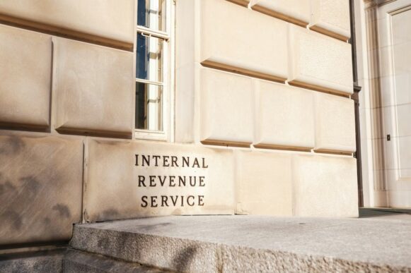 Internal Revenue Service building exterior with IRS signage on stone wall.