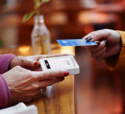 two-people-exchanging-a-credit-card-at-a-table-_SAP CX AI update