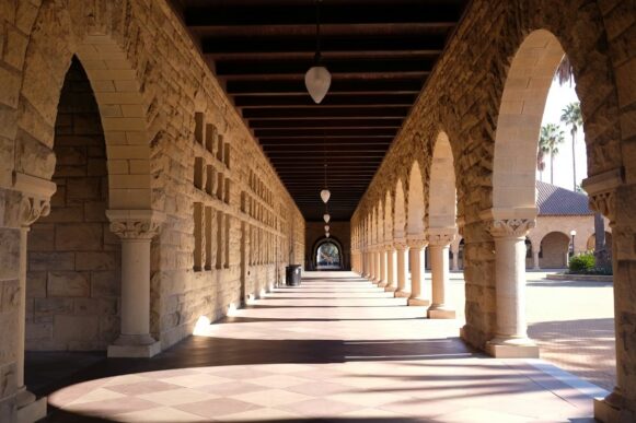 Stanford University campus building with modern geometric architecture under a clear blue sky, reflecting the institutional setting behind the Stanford AI Index 2026 report.