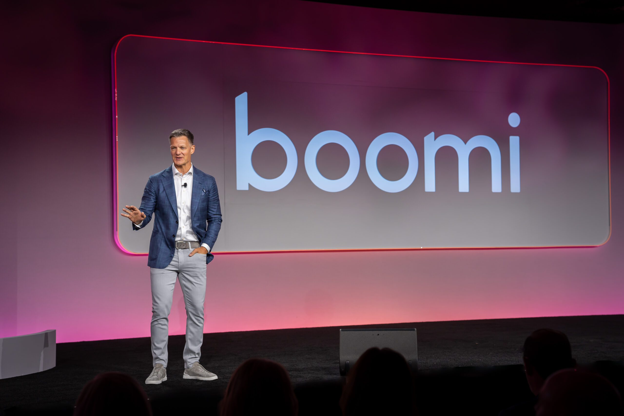 Steve Lucas, CEO of Boomi, speaking on stage at the Boomi World 2026 conference with the large Boomi logo displayed on a digital screen behind him.