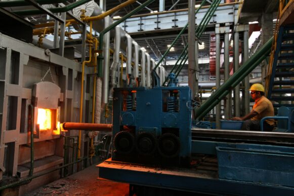 a-man-in-a-factory-with a furnace_RHI Magnesita SAP S/4HANA modernization
