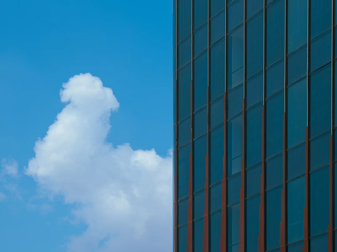 Office building against a blue sky representing cloud migration and clean core alignment for Pathlock’s RISE with SAP certification.