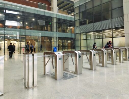 People pass through a secure building entrance, illustrating access governance and SAP IDM migration planning.