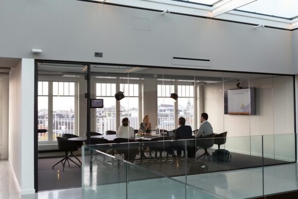 A business team meets in a conference room, reflecting the SAP S/4HANA migration strategy discussions that can lead to Selective Data Transition decisions.