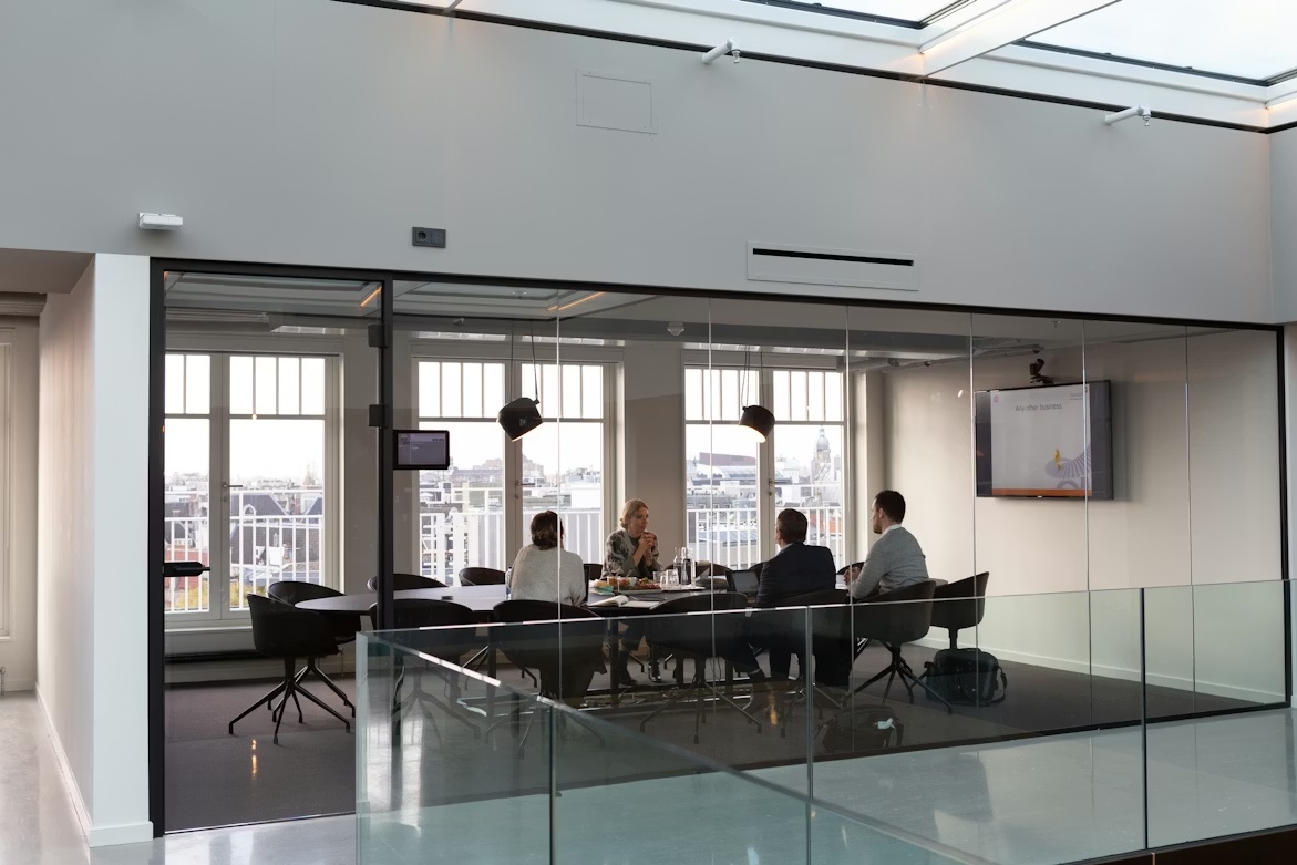 A business team meets in a conference room, reflecting the SAP S/4HANA migration strategy discussions that can lead to Selective Data Transition decisions.
