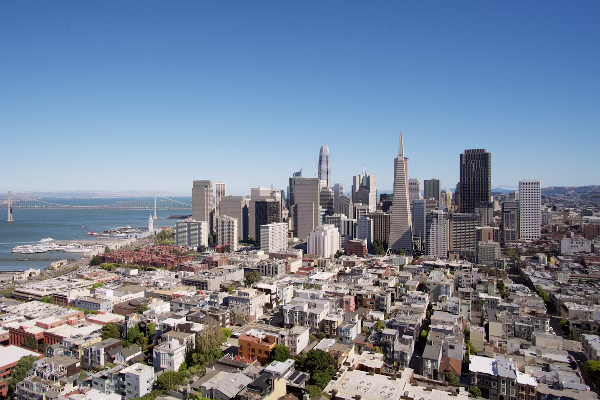 San Francisco skyline, where Nuvo is based, with downtown buildings and the Bay Bridge under a clear blue sky.