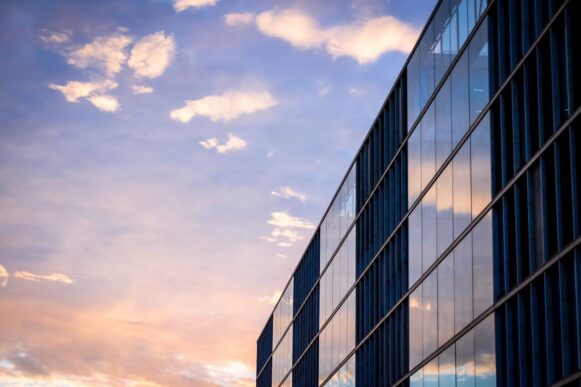 Modern glass office building representing SAP Cloud ALM deployment automation and BTP-native release governance