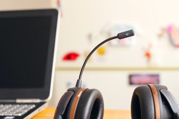Customer service headset beside a laptop, representing the future of SAP Autonomous CX and AI-enabled service workflows.