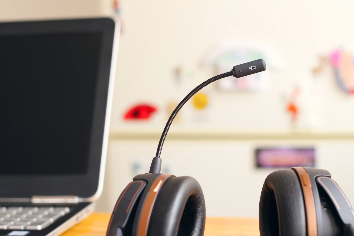 Customer service headset beside a laptop, representing the future of SAP Autonomous CX and AI-enabled service workflows.