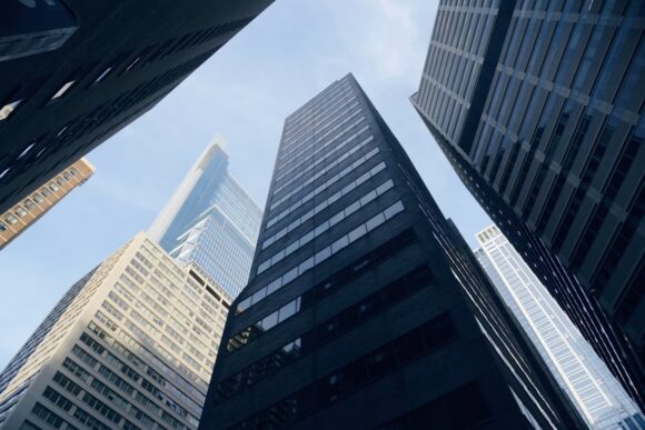 Tall glass office buildings viewed from below, representing the enterprise architecture and execution-control challenges behind SAP autonomous enterprise adoption.