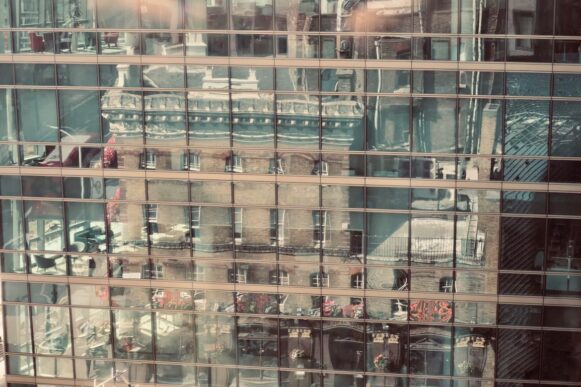 Modern glass building reflecting historic architecture, representing SAP BusinessObjects migration and analytics modernization