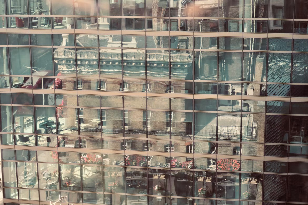 Modern glass building reflecting historic architecture, representing SAP BusinessObjects migration and analytics modernization