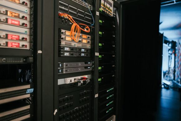 Server racks and networking equipment in a data center, representing SAP data archiving and HANA migration infrastructure.
