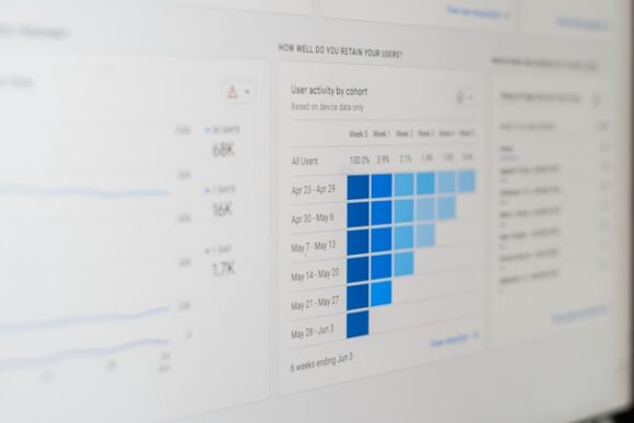 Illustrated digital workspace with computer screen, data icons, and collaboration tools representing McKinsol Consulting SAP master data governance and clean core managed services.