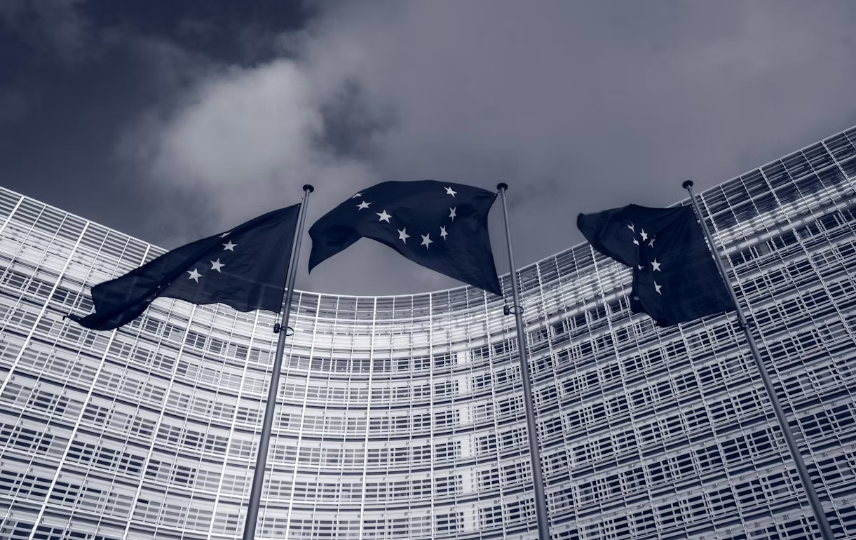 European Union flags outside the European Commission’s Berlaymont building in Brussels, representing Article 50 EU AI Act transparency rules.