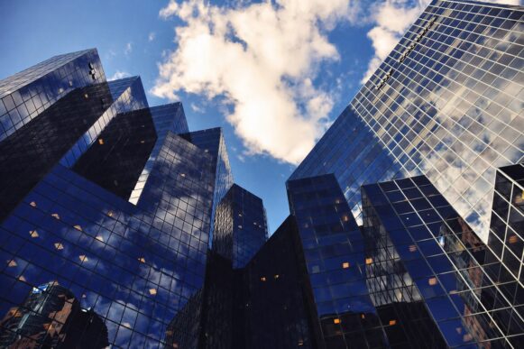 Reflective glass office towers representing measurable AI value in complex SAP operations.