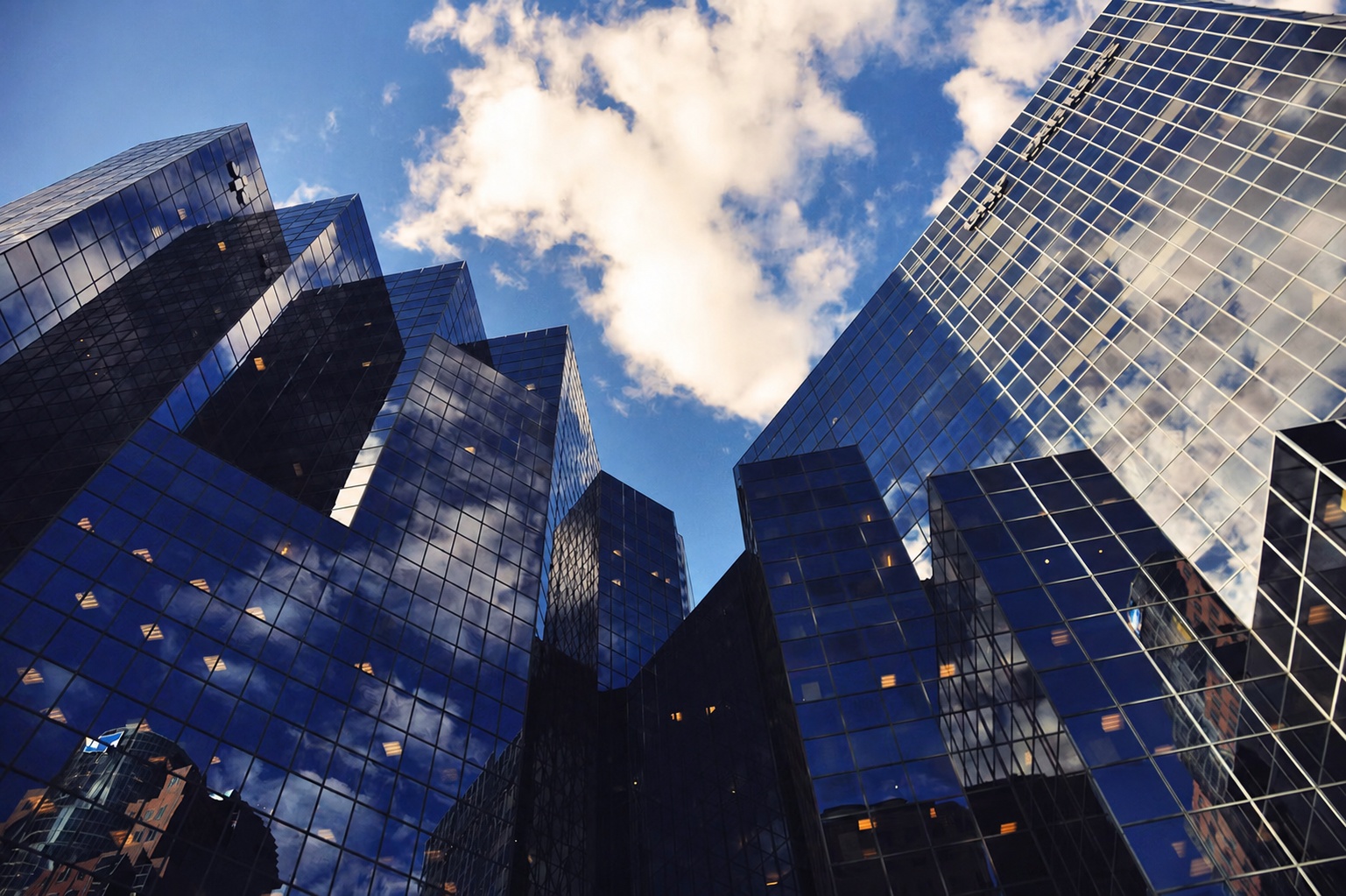 Reflective glass office towers representing measurable AI value in complex SAP operations.
