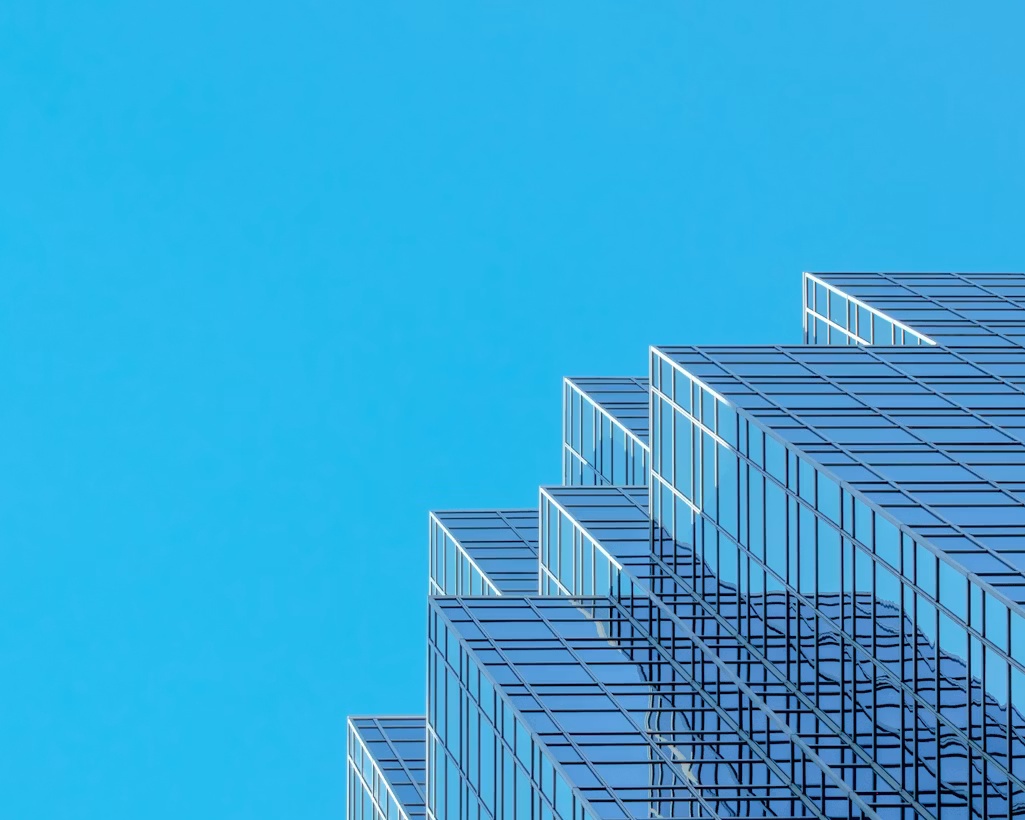 Modern glass office building representing structured agentic orchestration across enterprise workflows
