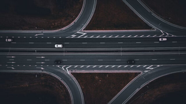 Aerial view of cars moving through a multilane highway interchange, illustrating SAP’s phased finance AI rollout.