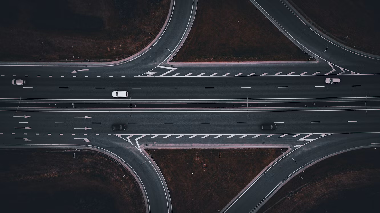 Aerial view of cars moving through a multilane highway interchange, illustrating SAP’s phased finance AI rollout.