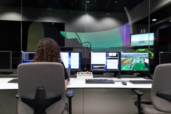 Analyst monitoring multiple screens in an enterprise operations control room, representing the continuous SAP application management and governance behind SAP S/4HANA migration services.