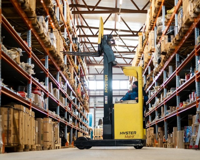 Forklift operator retrieving warehouse inventory for available-to-promise order fulfillment supported by SAP Business One