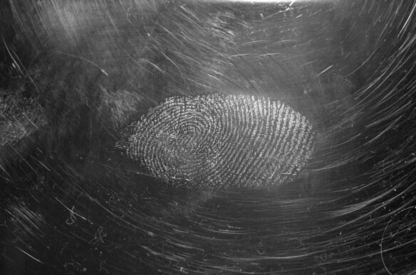Fingerprint on a reflective surface representing AI content provenance and traceability