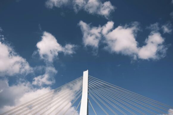 Cable-stayed bridge beneath clouds representing connected SAP and cloud environments for RISE with SAP automation.