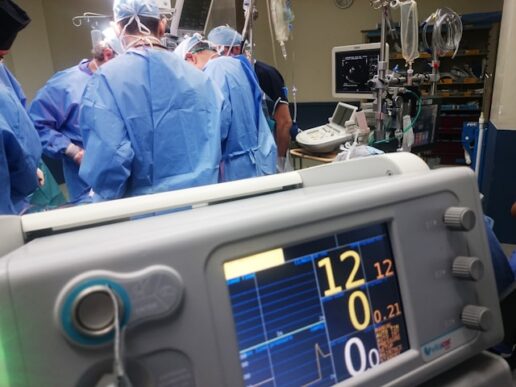 Surgical team in an operating room surrounded by medical monitors and equipment, representing the hospital buyers and clinical products behind Boston Scientific's AI-powered B2B product discovery on SAP Commerce Cloud