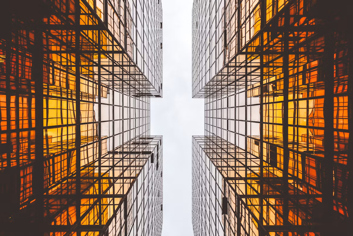 Symmetrical glass office buildings with illuminated grid patterns representing structured SAP Business One data