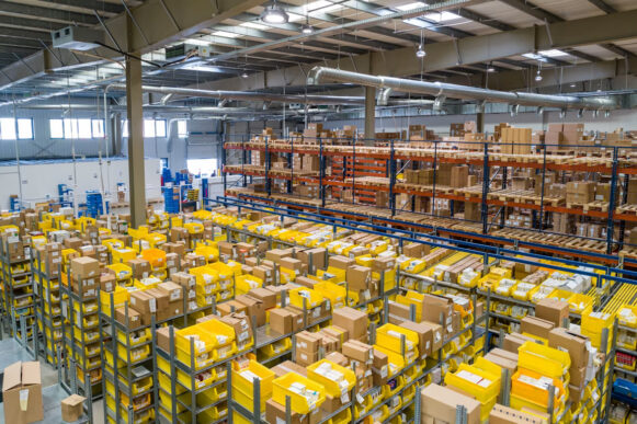 Warehouse distribution center filled with packages and labeled inventory managed through SAP operations