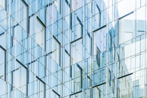 Glass building facade illustrating connected SAP security controls and NIS2 compliance visibility