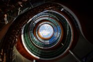Circular glass atrium with layered architecture and a hexagonal skylight, illustrating complexity and interconnected enterprise systems.