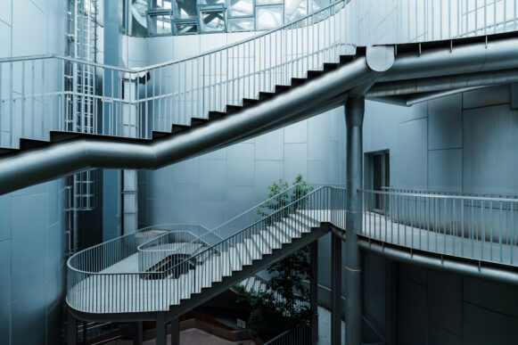 Interconnected metal staircases and walkways inside a modern building, illustrating access paths and security risks in SAP systems.